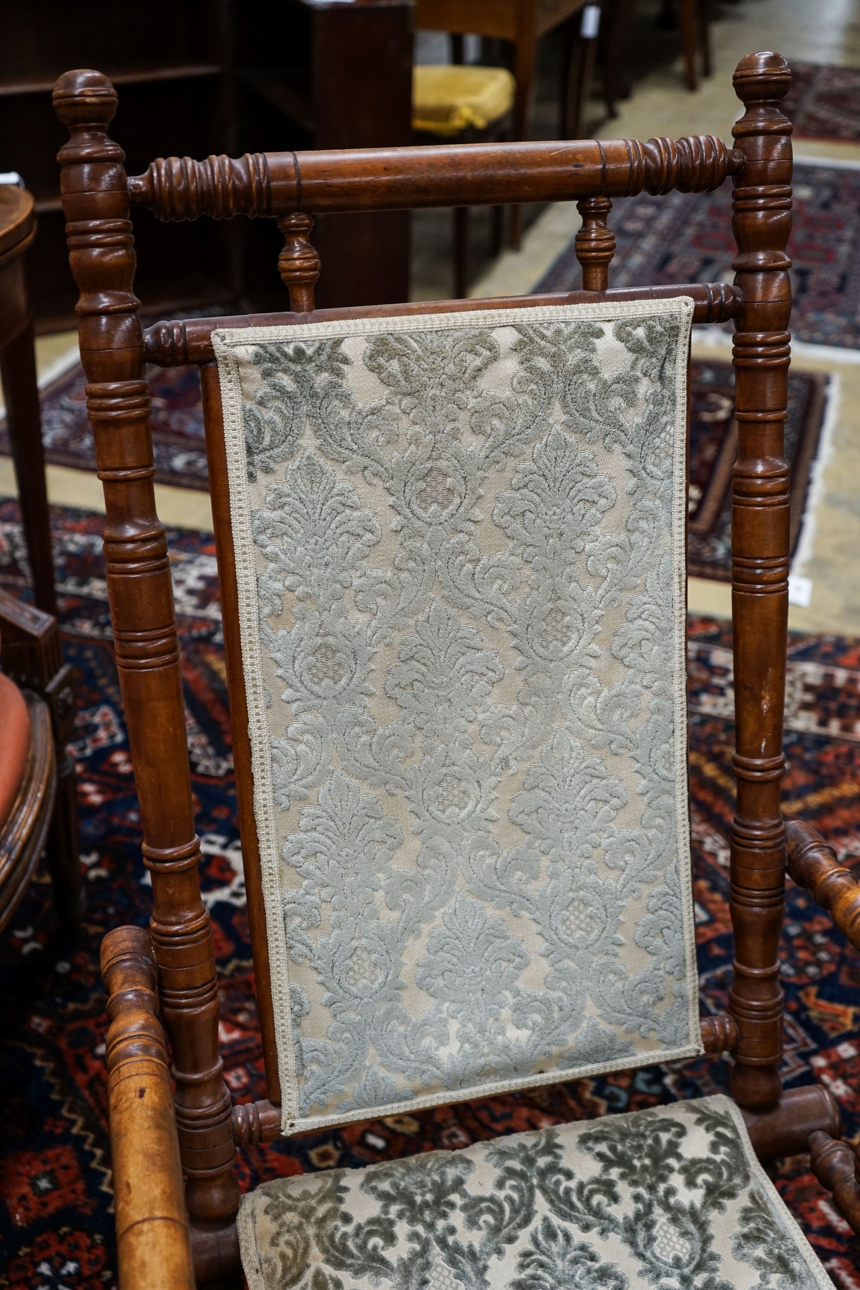 An early 20th century American rocking chair, width 54cm, depth 50cm, height 106cm